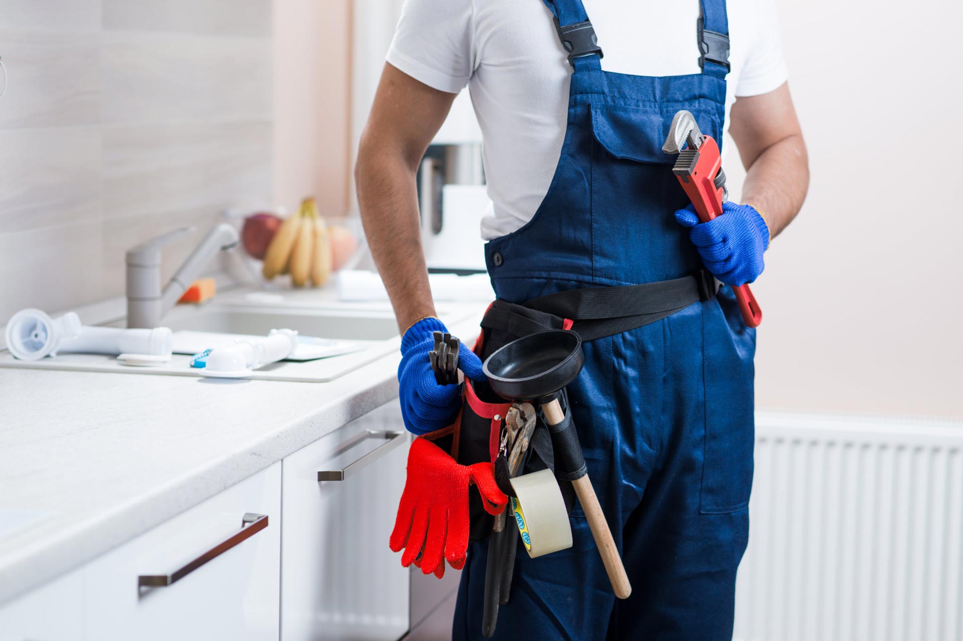 Plumber inspecting a residential water pipe system